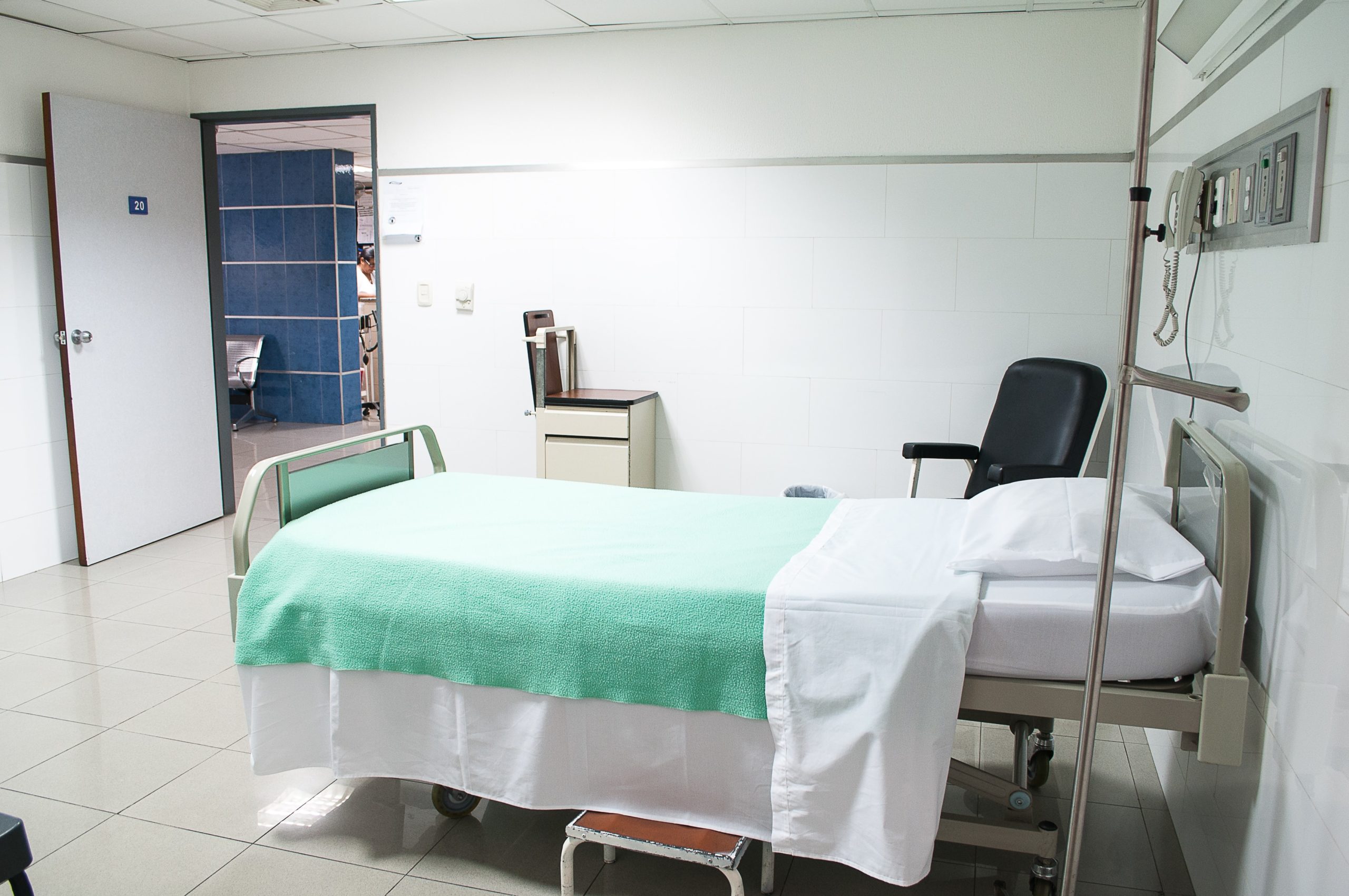 a hospital room with a bed and a chair